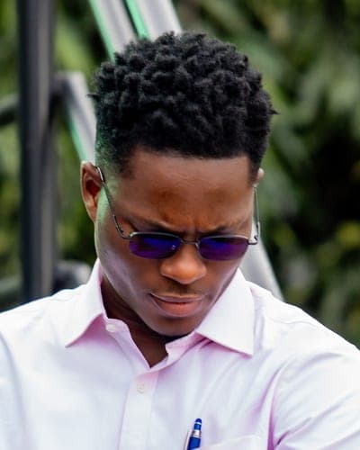 Obed Afram, head and shoulders, in tinted glasses